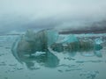 Iceberg drifting in the polar ocean in the arctic. Cloudy Day. Tourism and vacations concept.