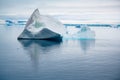 Shiny iceberg floating in calm water on foggy morning in Antarctica. Typical misty day in Antarctica.