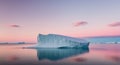 An Iceberg Floating in Calm Waters with a Pink and Blue Sky. Royalty Free Stock Photo