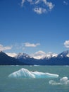 Iceberg floating in front of Mountains