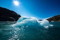 Iceberg floats in crystal clear water of Mosevatnet Lake with Folgefonna Glacier in the background Royalty Free Stock Photo