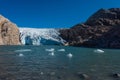 Iceberg floats in crystal clear water of Mosevatnet Lake with Folgefonna Glacier in the background Royalty Free Stock Photo
