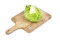 Iceberg lettuce on wooden cutting board, leafy green vegetable isolated on white background Royalty Free Stock Photo