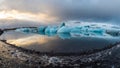 Iceberg Reflection on water at sunset, golden colors and blue ice Royalty Free Stock Photo