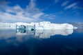 Iceberg with reflections in blue water of Southern Ocean, Antarctica