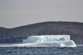 Icebergs adjacent to steep cliff in bay outside St. John\'s