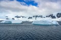 Icebergs with beautiful pattern in front of snow-capped mountains, Antarctica Royalty Free Stock Photo