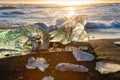 Icebergs on the cost of the black sand beach in the rays of the rising sun, Jokulsarlon, southeast Iceland Royalty Free Stock Photo