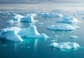 Icebergs float in the cold, clear waters of Antarctica. The icebergs vary in size and Royalty Free Stock Photo