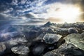 Icebergs floating in Jokulsarlon at sunset golden hour with glac