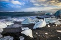 Icebergs floating in Jokulsarlon at sunset golden hour with glac