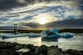 Icebergs floating in Jokulsarlon at sunset golden hour with glac