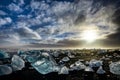 Icebergs floating in Jokulsarlon at sunset golden hour with glac