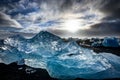 Icebergs floating in Jokulsarlon at sunset golden hour with glac