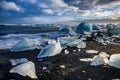 Icebergs floating in Jokulsarlon at sunset golden hour with glac