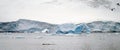 Icebergs floating in the ocean near the snowy peaks of Antarctica. Royalty Free Stock Photo