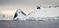 Icebergs floating in the ocean near the snowy peaks of Antarctica. Royalty Free Stock Photo