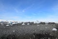 Icebergs Scattered Around a Volcanic Black Rock Beach Royalty Free Stock Photo