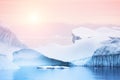 Icebergs on the shore of Atlantic ocean at sunset, Greenland