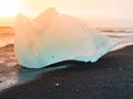 Icebergs sphashed by sea waves on black beach at sunrise time near Jokulsarlon glacier lake, Iceland Royalty Free Stock Photo