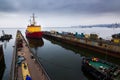 Icebreaker ship enters floating dock, marine engineering prowess. Vessel maintenance at shipyard, maritime logistics Royalty Free Stock Photo