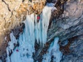 Iceclimber climbing a frozen icefall. Extreme winter sports Royalty Free Stock Photo