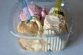 Icecreams balls in plastic box with colorful spoons Royalty Free Stock Photo