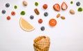 Icecreams with fruit and nut ingredients - ice cream cone on a white background