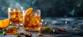 Iced amber whiskey with orange twist, a classic on a dark backdrop. Copy space