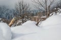 Fence details covered in snow in winter landscape - iced barb wire and wood at snow covered meadow in countryside Royalty Free Stock Photo