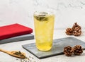 Iced Buckwheat Green Tea served in disposable glass isolated on board side view of taiwanese iced drink Royalty Free Stock Photo