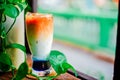 Iced butterfly pea latte on wooden table in coffee cafe , background coffee Royalty Free Stock Photo