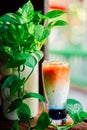 Iced butterfly pea latte on wooden table in coffee cafe , background coffee Royalty Free Stock Photo