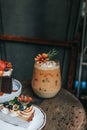 Iced caramel latte coffee with syrup and whipped cream decorate with flower. Royalty Free Stock Photo