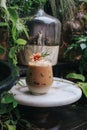 Iced caramel latte coffee with syrup and whipped cream decorate with flower. Royalty Free Stock Photo