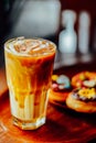 Iced caramel latte coffee in a tall glass on wood table ,  The drink menu . cafe image Royalty Free Stock Photo