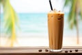 iced chai latte against a tropical beach background