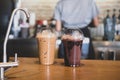 Iced chocolate and iced mocha on table with blurred back view of baretta Royalty Free Stock Photo