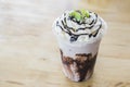Iced chocolate and whipped cream topped with milk float on wooden table Royalty Free Stock Photo