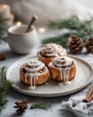 Iced cinnamon rolls on a plate, surrounded by pine cones, with a cozy winter theme Royalty Free Stock Photo
