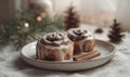 Iced cinnamon rolls on a plate, surrounded by pine cones, with a cozy winter theme Royalty Free Stock Photo