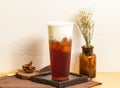 Iced Classic milk lid red served in disposable glass isolated on wooden board side view of taiwanese ice drink Royalty Free Stock Photo