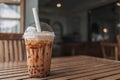 Iced cocoa boba bubble tea served on table in the cafe.