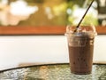 Iced cocoa in takeaway cup on table at cafe,Good summer drink