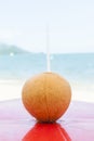 Iced coconut on a beach kiosk table..Brazilian tropical beach in hot summer on Ilhabela.