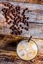 Iced coffee with beans for cold summer drink on wooden background top view Royalty Free Stock Photo