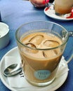 iced coffee, coffee with ice cubes, cold coffee drink, table, coffee in a transparent glass, cool drink and stimulant