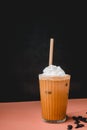 iced coffee or cold caffeine drink with whipping cream and straw on color background Royalty Free Stock Photo
