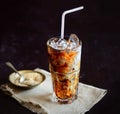 Iced coffee and cream, napkin, brown sugar on the dark background Royalty Free Stock Photo