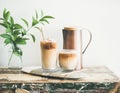 Iced coffee drink in tall glasses with milk, horizontal composition